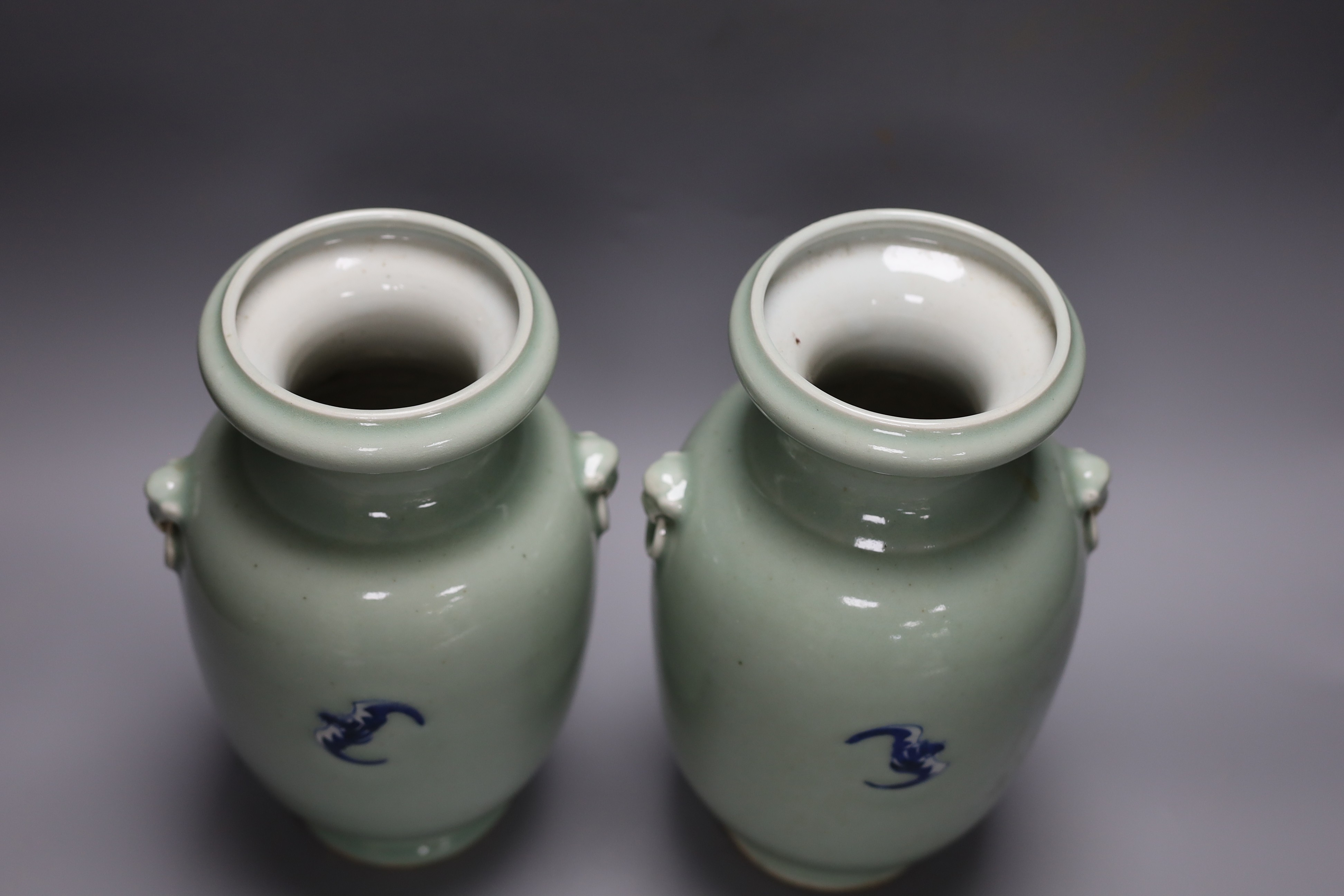 A pair of Chinese blue and white celadon ground vases, 26cms, painted with figures